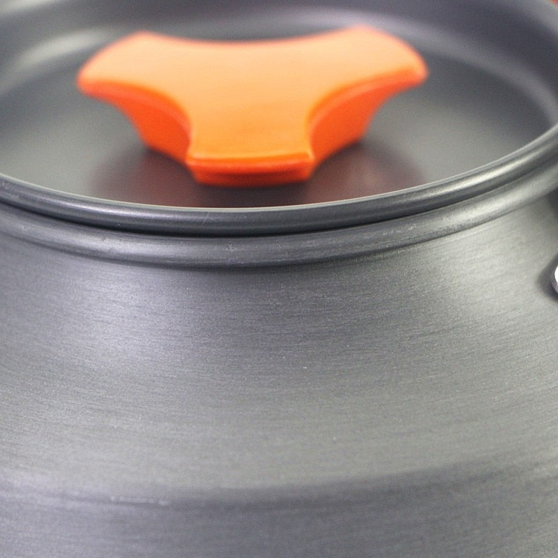 1.1L Camping Water Kettle made of aluminium alloy, perfect for outdoor coffee and cooking, shown in a natural setting.