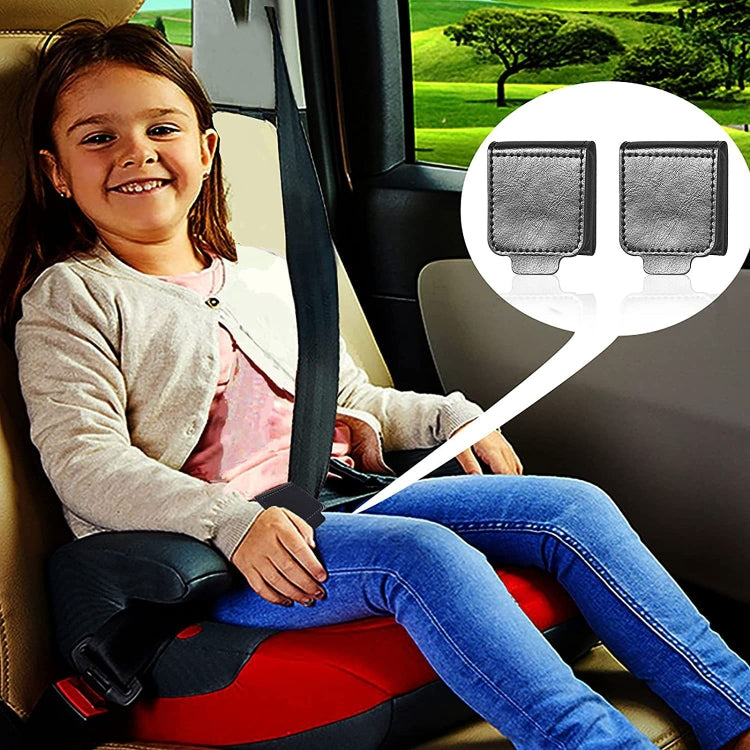 A pair of black car seat belt anti-strangle adjusters designed for children and adults, showcasing their compact size and high-quality leather material.