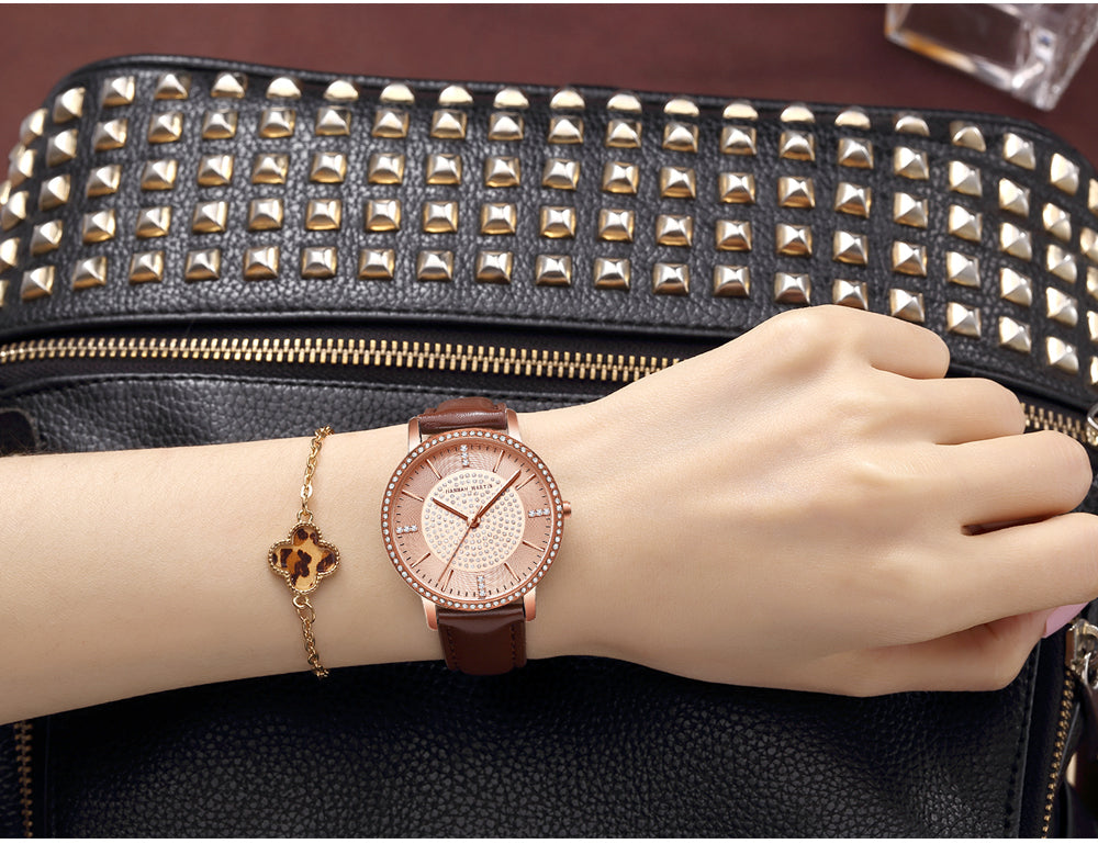 A luxurious women's bracelet watch featuring rhinestones and a quartz movement, elegantly designed with a brass case and stainless steel band.
