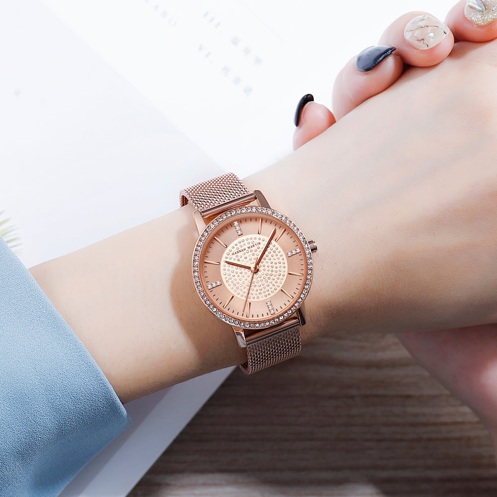 A luxurious women's bracelet watch featuring rhinestones and a quartz movement, elegantly designed with a brass case and stainless steel band.