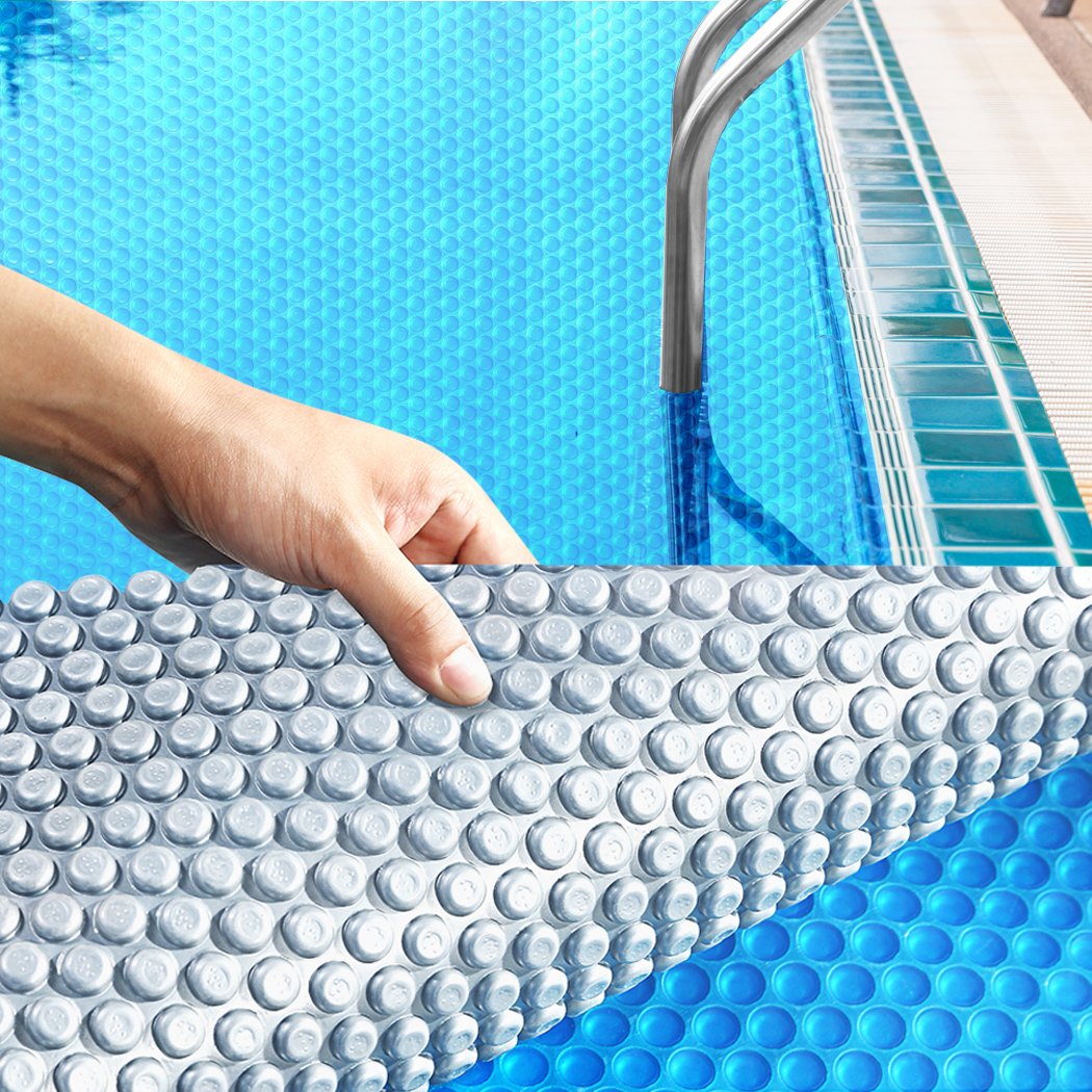 11x4.8M Solar Swimming Pool Cover in blue and silver, showcasing its durable design and bubble structure.