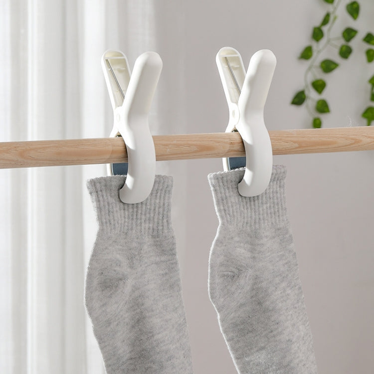 Two large blue plastic windproof clothespins designed for household use, showcasing their strong grip and durable material.