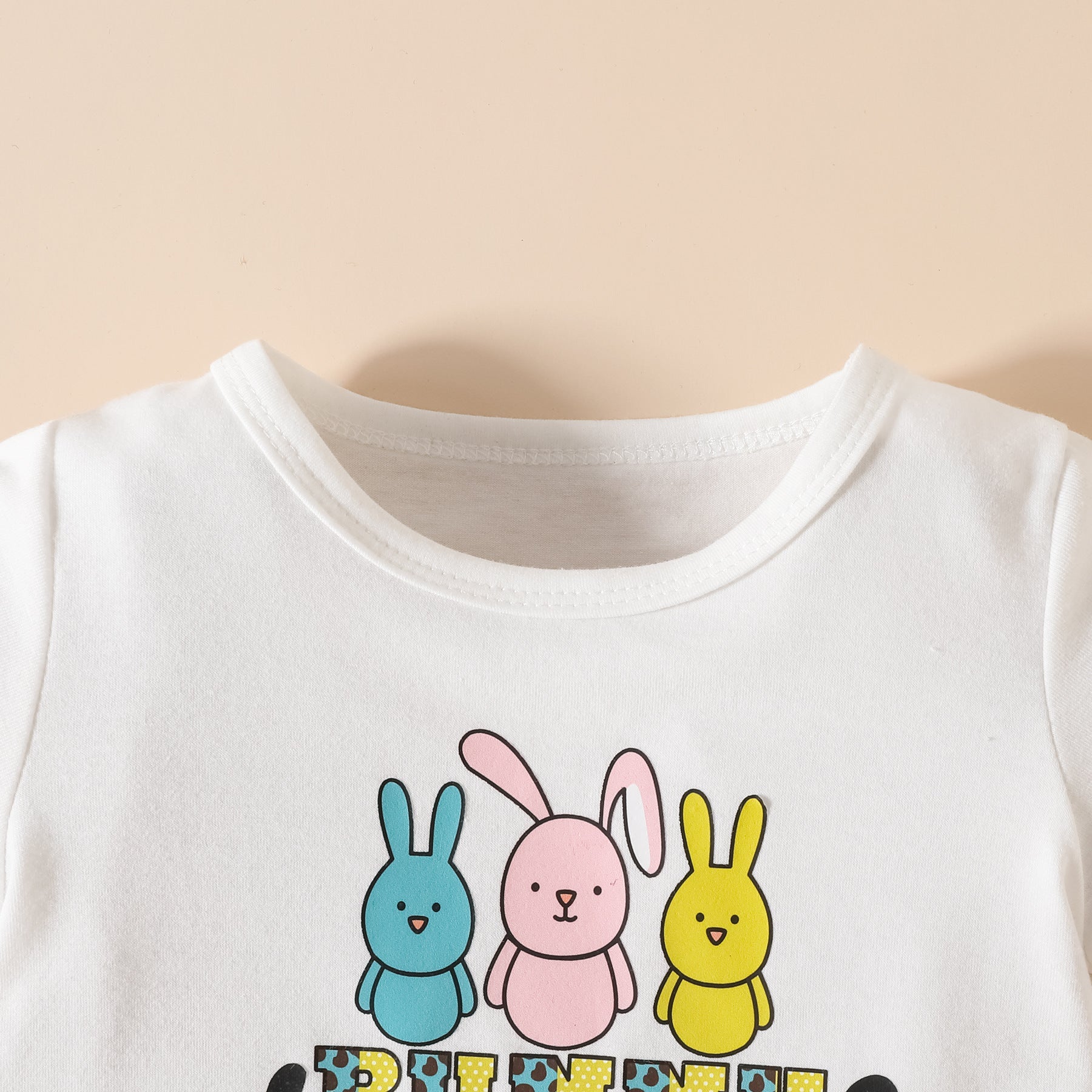 A vibrant 2 Pieces Set Baby Kid Girls Easter Letters Print T-Shirts And Cartoon featuring colorful prints, perfect for festive occasions.