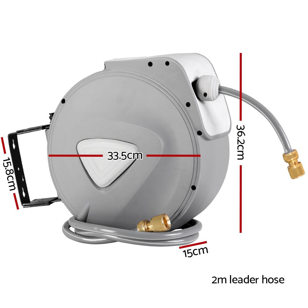 20M Retractable Water Hose Reel with grey casing, mounted on a wall, featuring a brass spray gun and a neatly coiled hose.