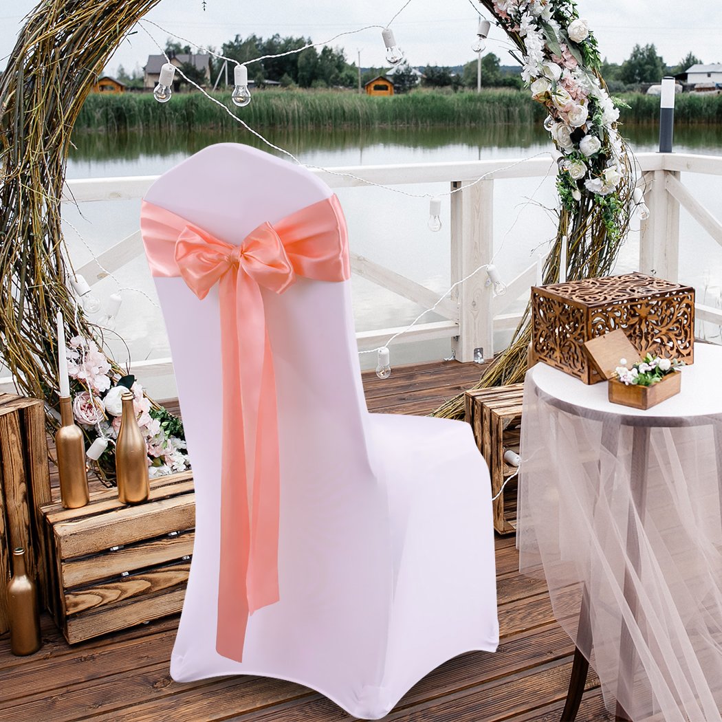 20 satin chair sashes in various colors elegantly draped over chairs for event decoration.