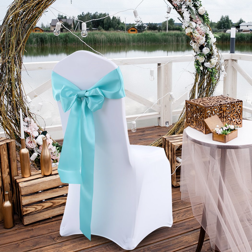 20 satin chair sashes in various colors elegantly draped over chairs, perfect for weddings and events.
