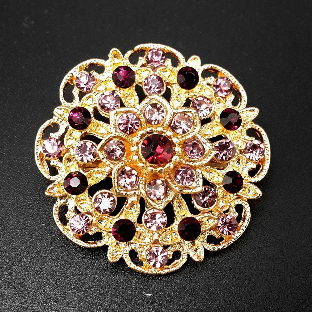 A collection of 24 vintage-style brooches featuring mixed alloy and rhinestone crystals, showcasing various floral designs.