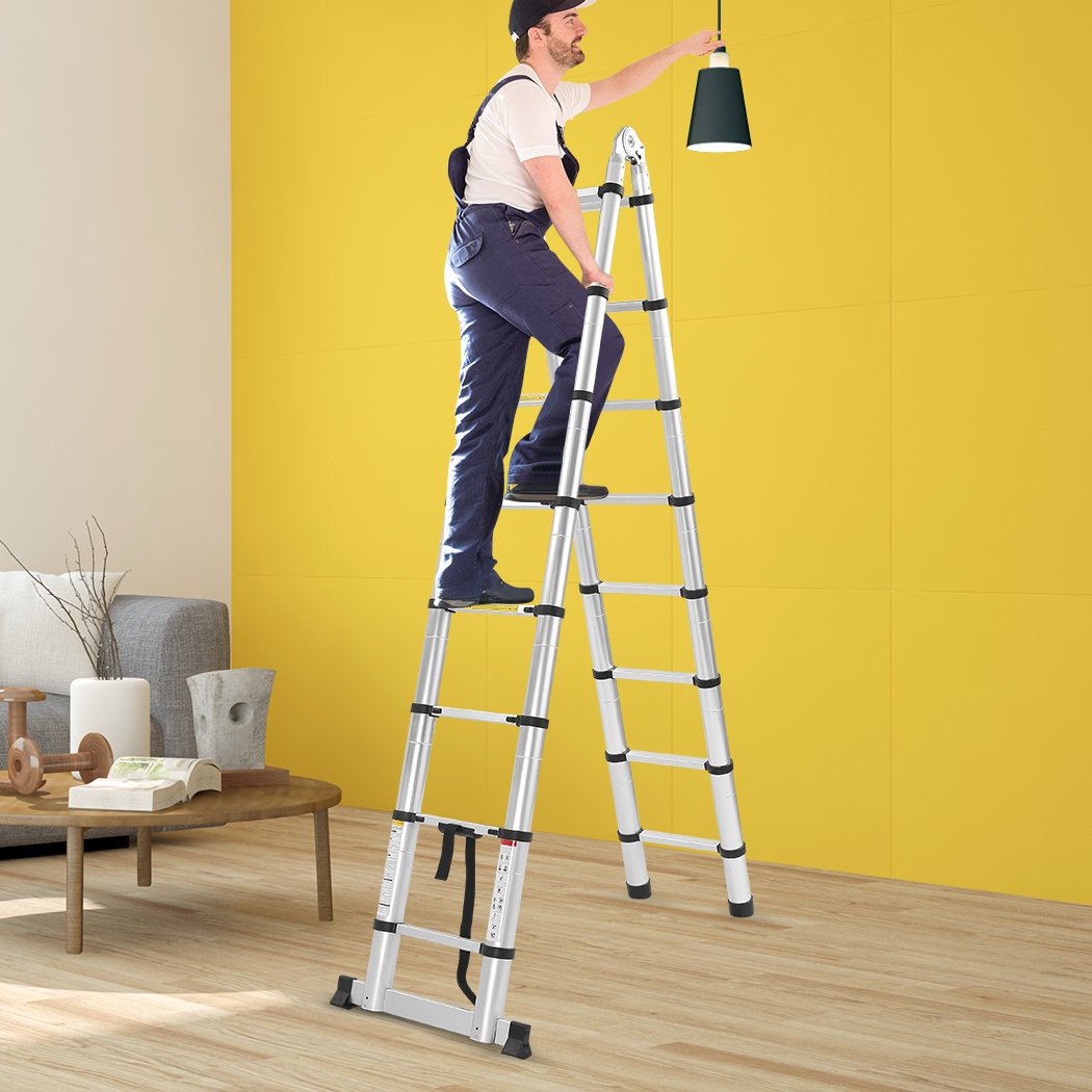 2M Telescopic Aluminium Multipurpose Ladder with anti-skid footboard and rubber-tipped feet, showcasing its extendable design.