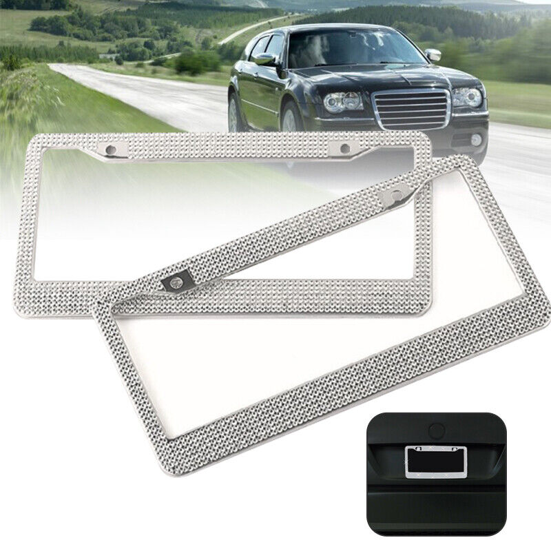 Two sparkling rhinestone license plate frames, showcasing a glittering design with multifaceted crystals, perfect for enhancing vehicle aesthetics.