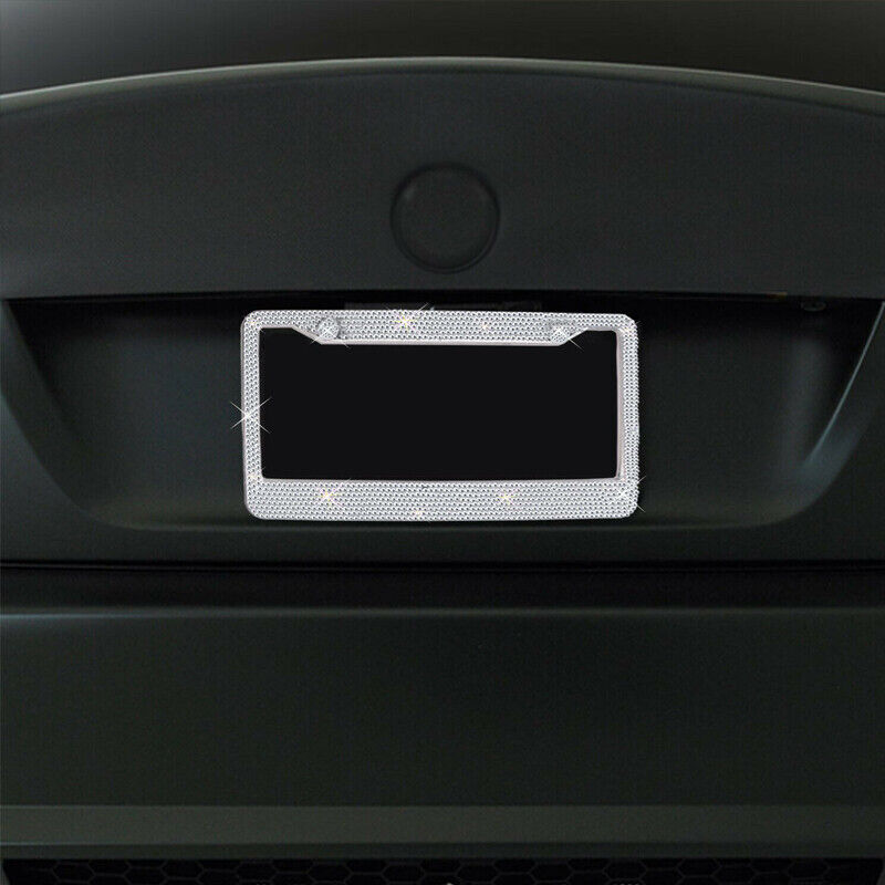 Two sparkling rhinestone license plate frames, showcasing a glittering design with multifaceted crystals, perfect for enhancing vehicle aesthetics.