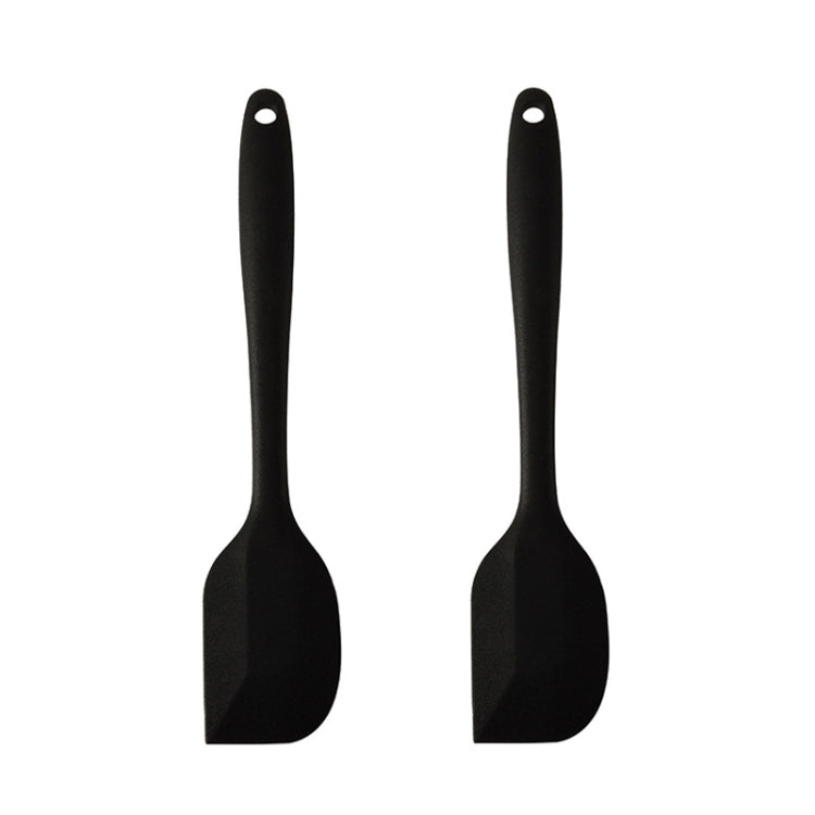 Two large integrated silicone scrapers with rounded handles, ideal for mixing chocolate and cream in the kitchen.