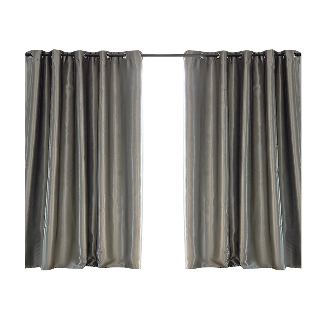 Elegant grey 2X blockout curtains hanging in a bedroom, showcasing their thick fabric and stylish design.