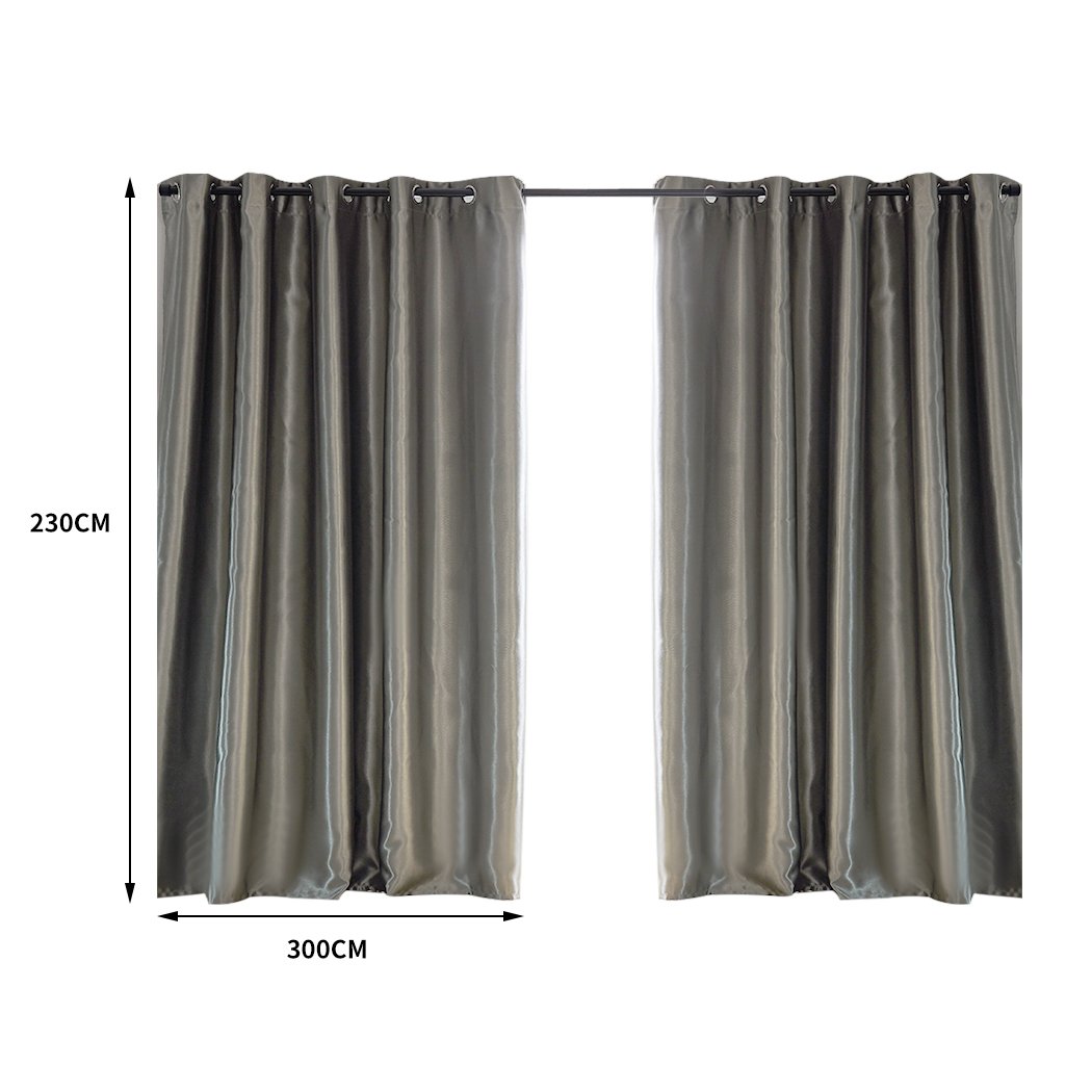 Elegant grey 2X blockout curtains hanging in a bedroom, showcasing their thick fabric and stylish design.