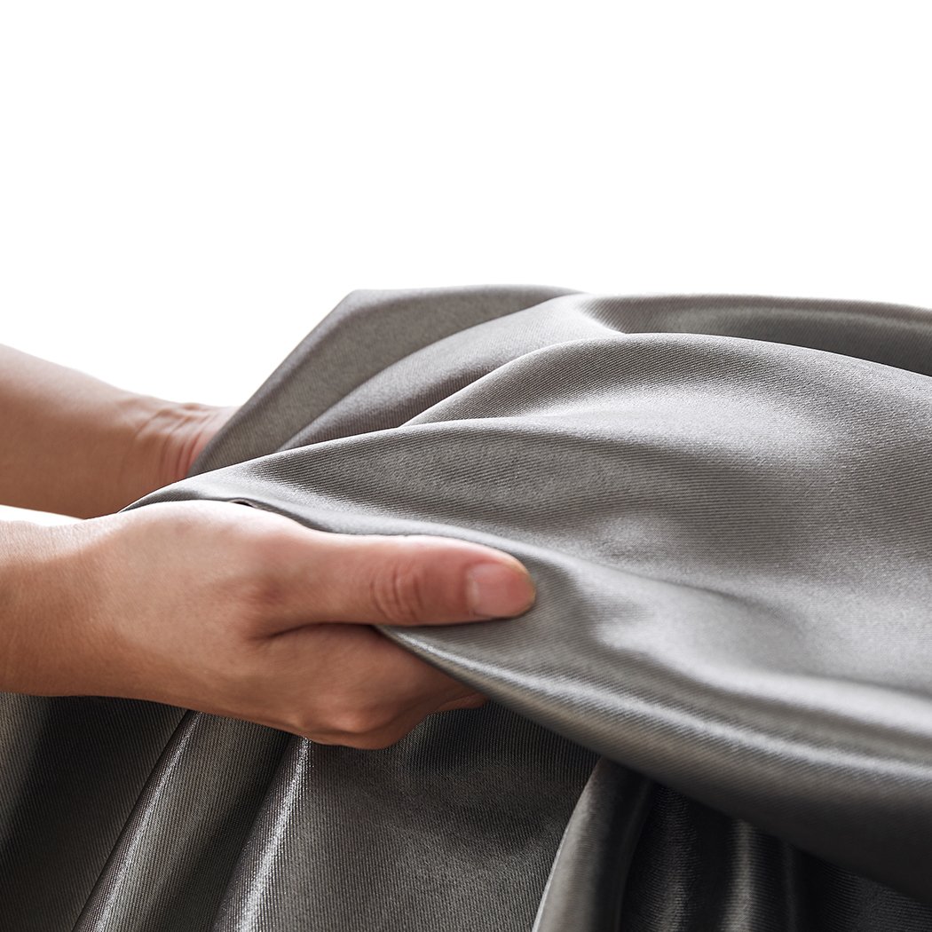 Elegant grey 2X blockout curtains with eyelet design, perfect for bedroom windows, providing light blocking and noise reduction.