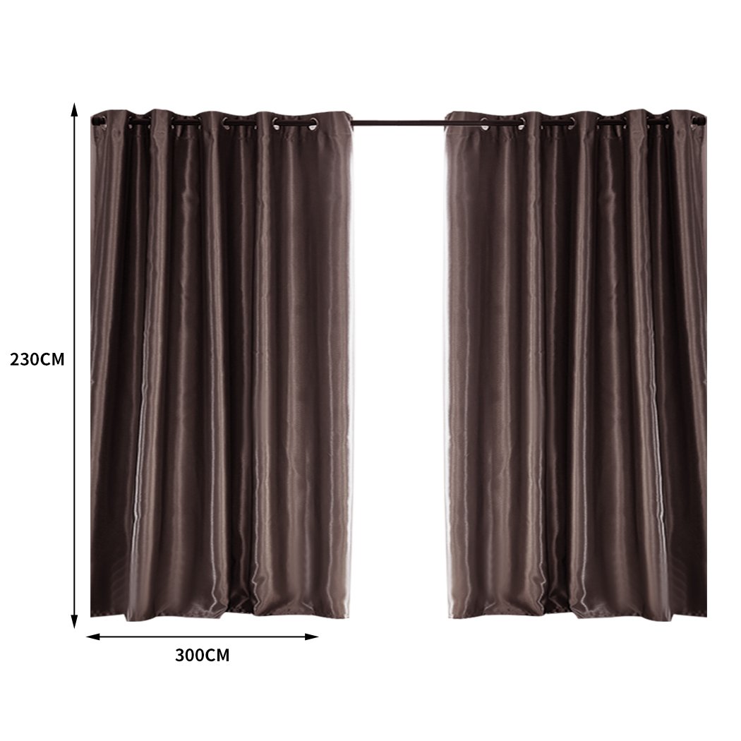 Elegant taupe 2X blockout curtains with eyelet design, providing light and noise blocking for a serene bedroom environment.