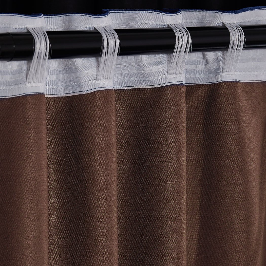 Elegant stone-colored 2X blockout curtains hanging in a stylish bedroom, showcasing their premium quality and design.