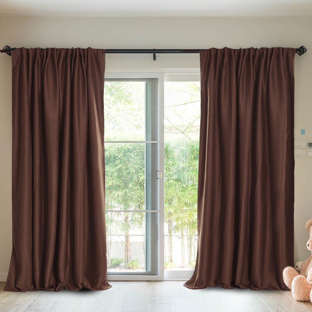 Elegant stone-colored 2X blockout curtains hanging in a stylish bedroom, showcasing their premium quality and design.