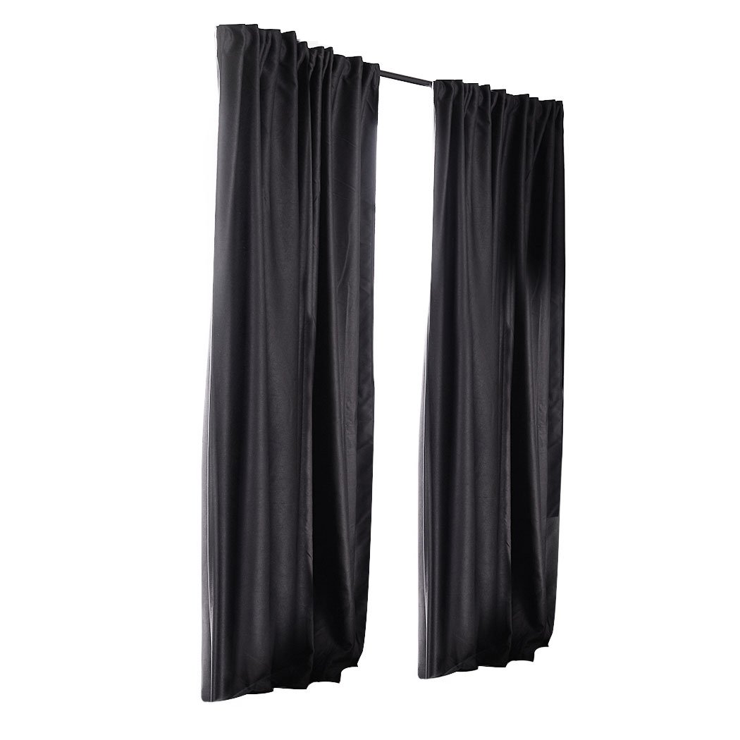 Two dark grey blockout curtains hanging elegantly in a bedroom, showcasing their premium quality and stylish design.