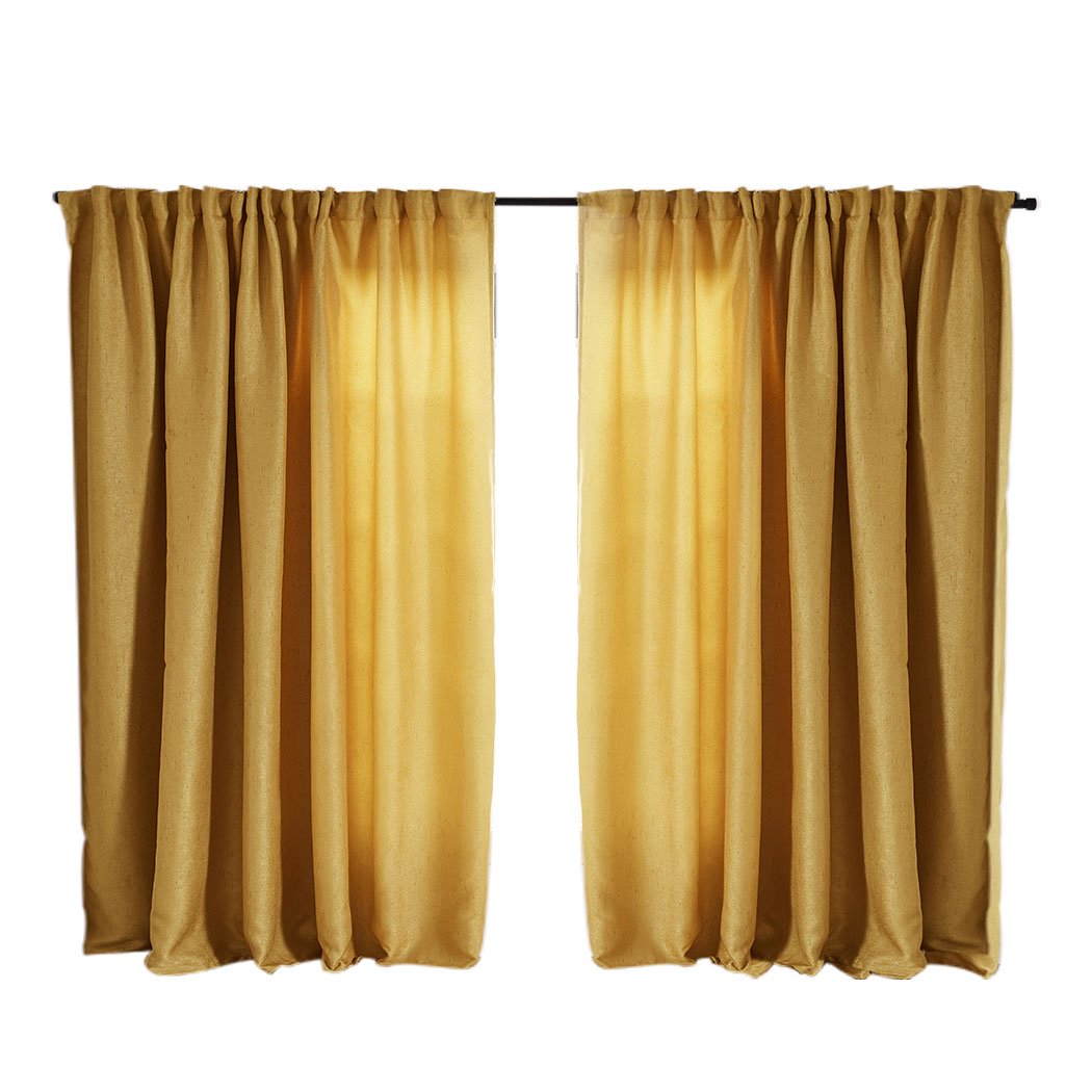 Elegant mustard blockout curtains hanging in a living room, showcasing their rich texture and vibrant color.