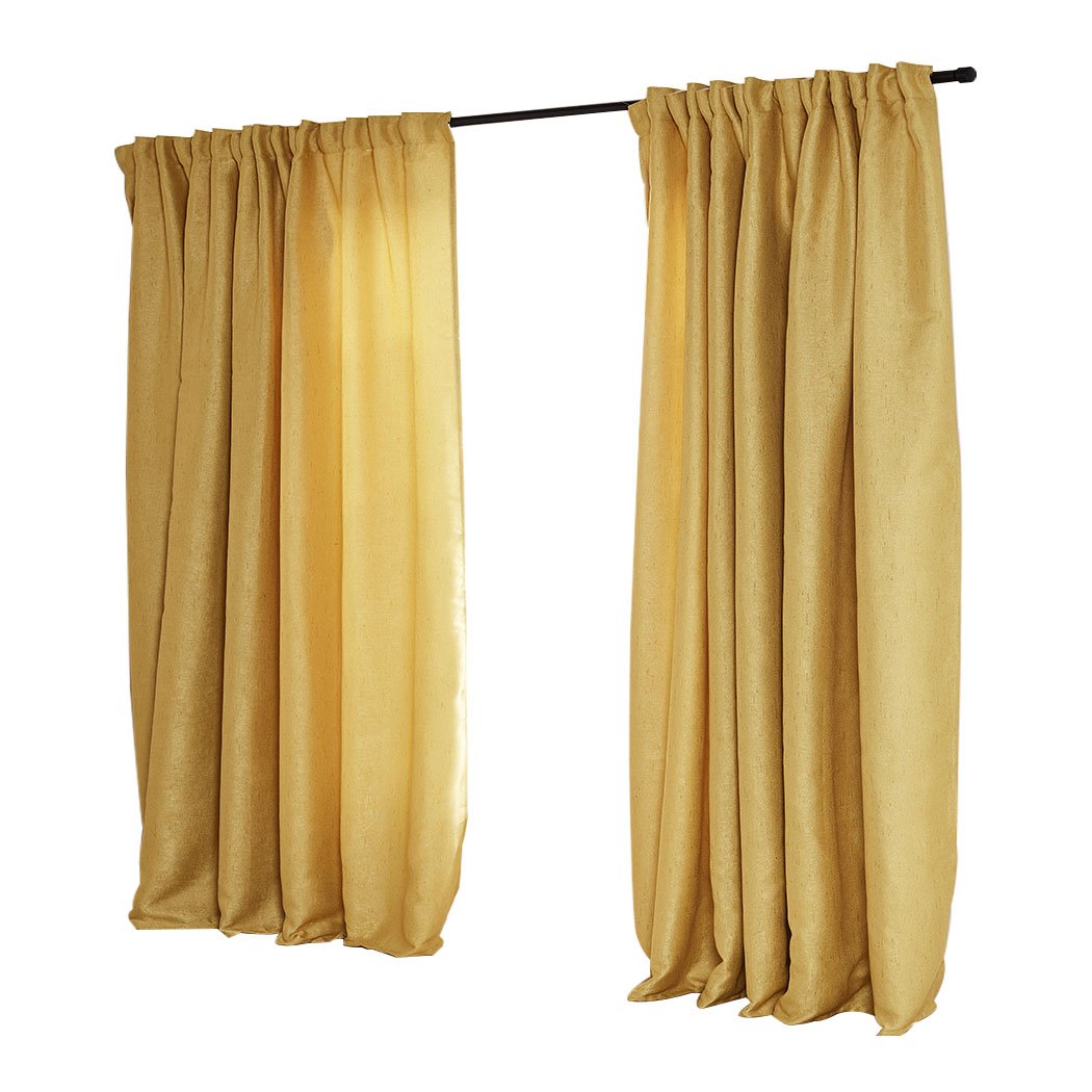 Elegant mustard blockout curtains hanging in a living room, showcasing their rich texture and vibrant color.