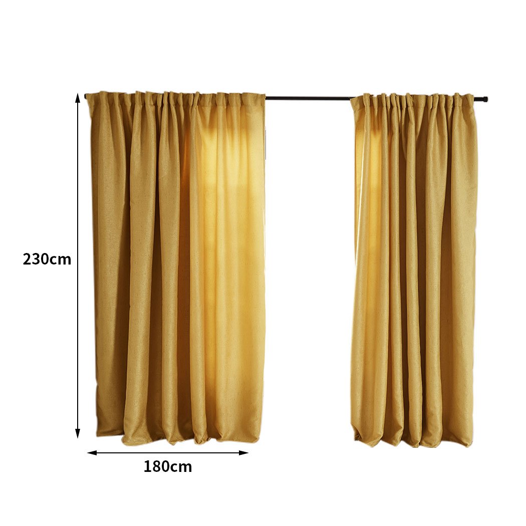 Elegant mustard blockout curtains hanging in a living room, showcasing their rich texture and vibrant color.