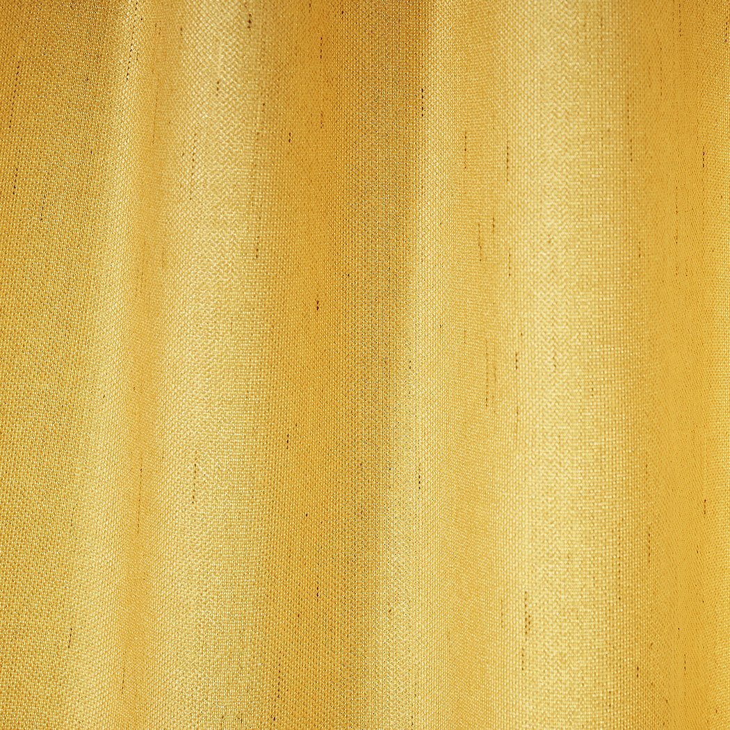 Elegant mustard blockout curtains hanging in a living room, showcasing their rich texture and vibrant color.