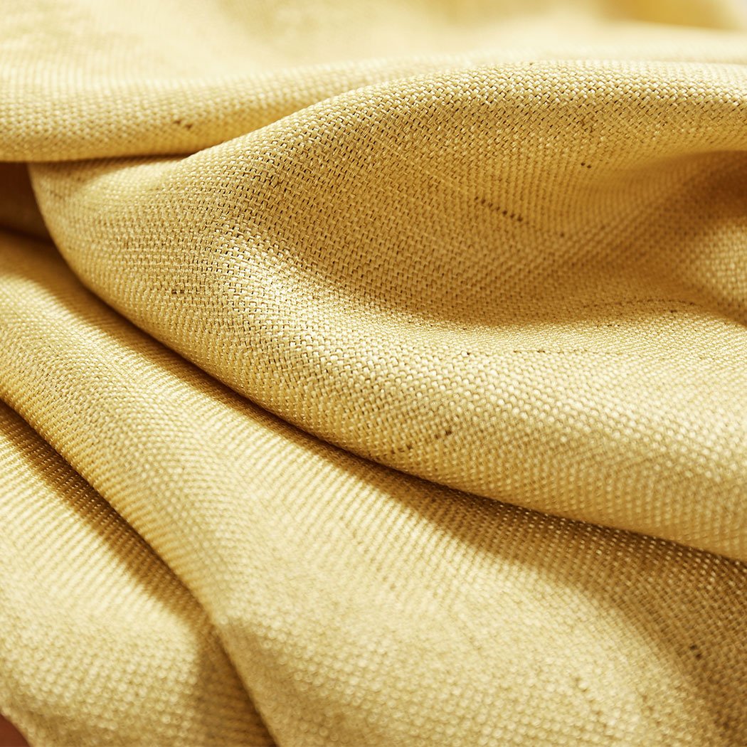 Elegant mustard blockout curtains hanging in a living room, showcasing their rich texture and vibrant color.