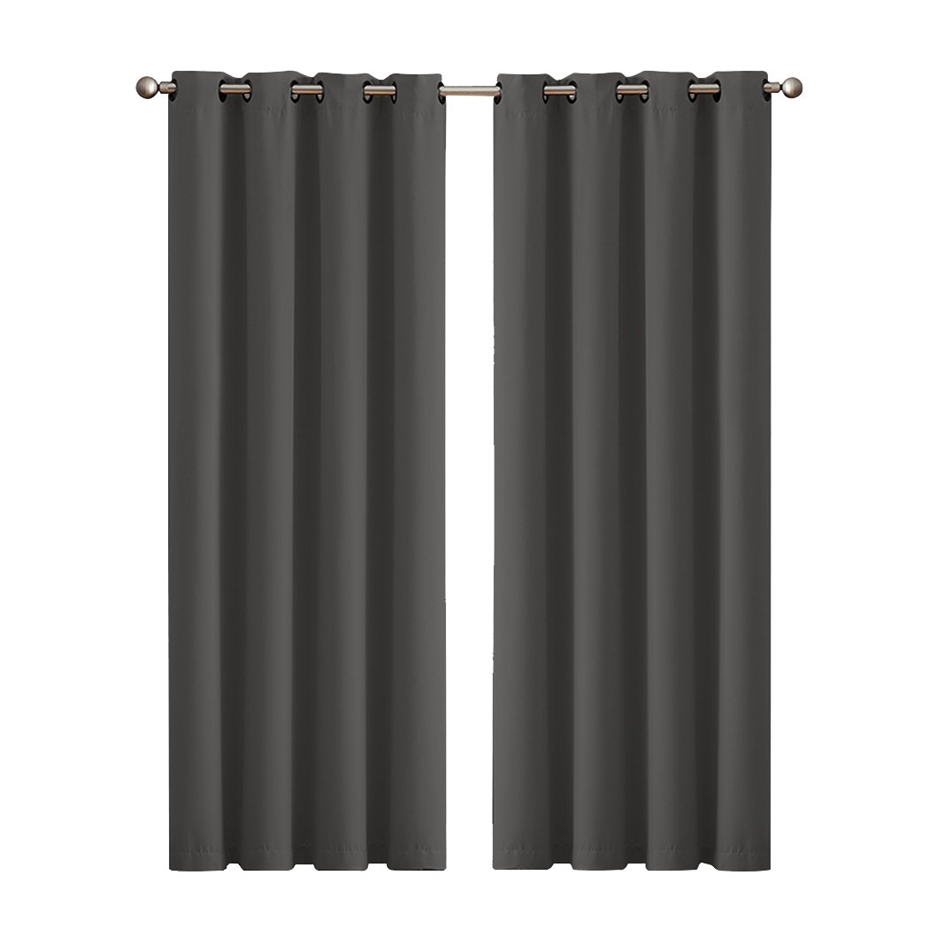 Two elegant blockout curtain panels in vibrant color, featuring eyelet design and triple weave fabric, perfect for room darkening and noise insulation.
