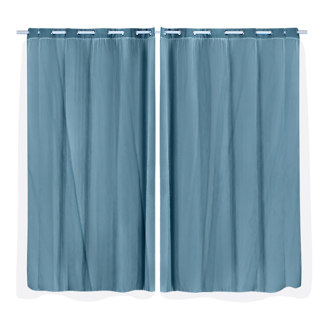Two elegant blockout curtain panels with gauze, designed for maximum light control and stylish draping in a modern interior.