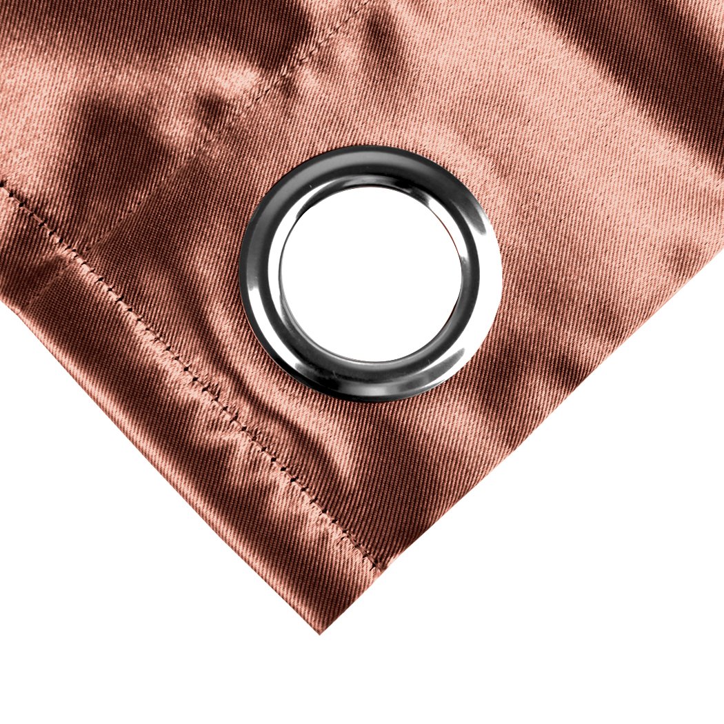 Two elegant blockout curtain panels in vibrant color, showcasing eyelet design and three-layer construction for effective room darkening.