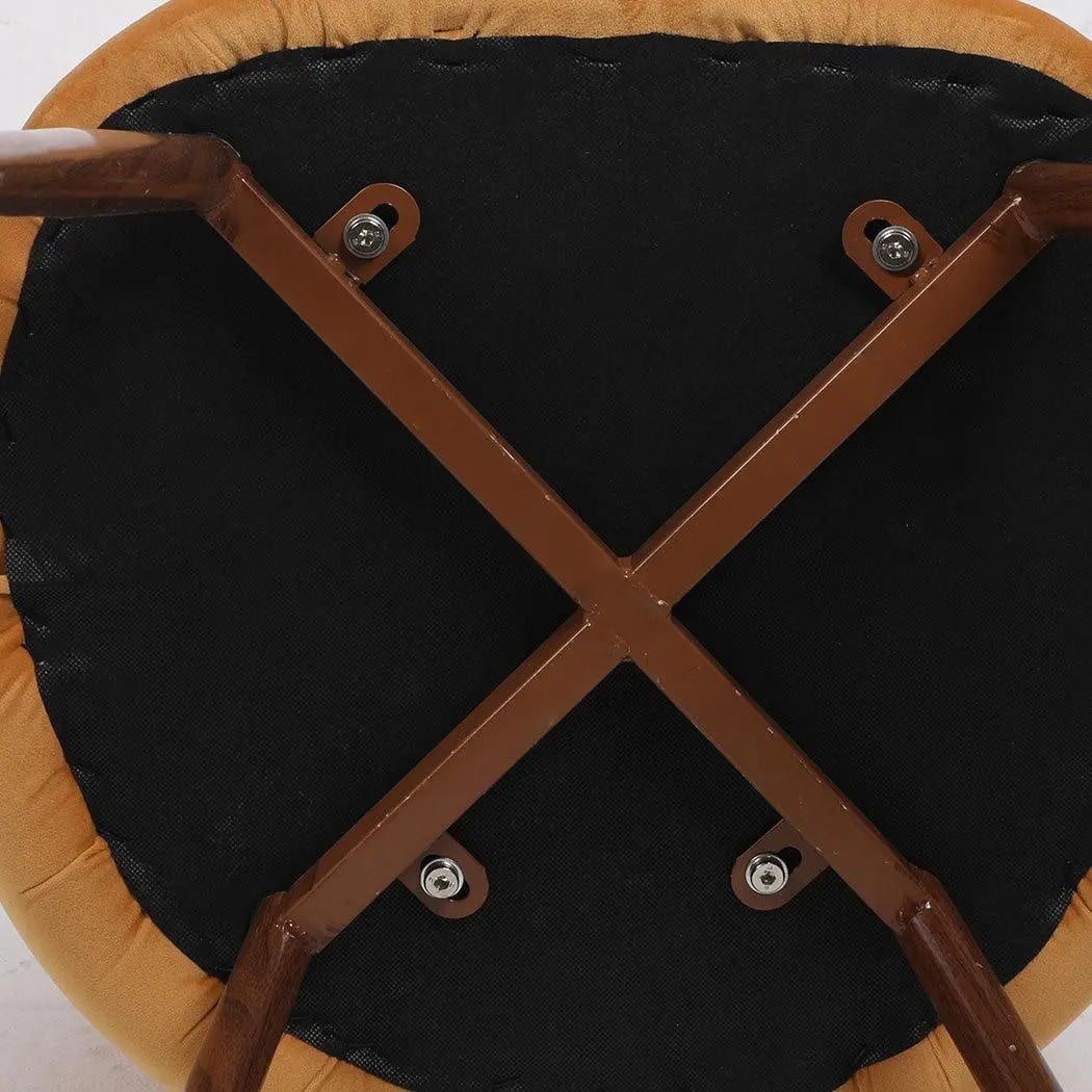 Set of two mustard dining chairs with plush velvet upholstery and sturdy steel legs, perfect for kitchen or lounge use.