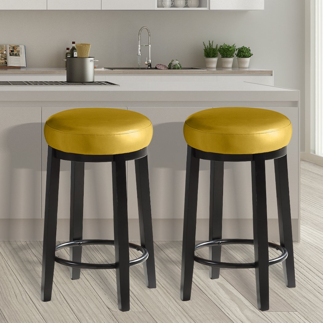 Two Levede 75cm swivel bar stools with solid wood frame and PU leather seat, featuring a bronze-finished footrest.