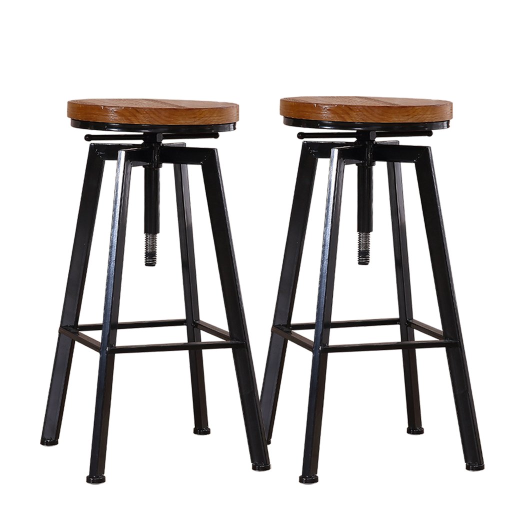 Two Levede Industrial Bar Stools with wooden seats and heavy-duty steel frames, showcasing a vintage industrial design.