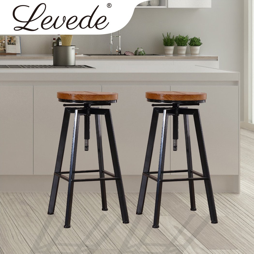 Two Levede Industrial Bar Stools with wooden seats and heavy-duty steel frames, showcasing a vintage industrial design.