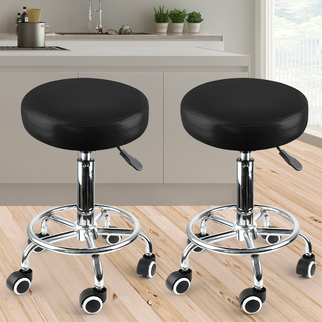 Two Levede Swivel Salon Barstools with black PU leather cushions and silver chromed iron bases, showcasing their 360-degree swivel and hydraulic lift features.