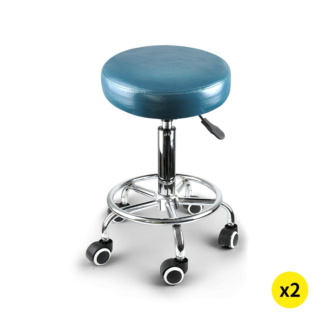 Two teal Levede swivel salon barstools with a round cushion and chrome base, designed for hairdressing and barber use.