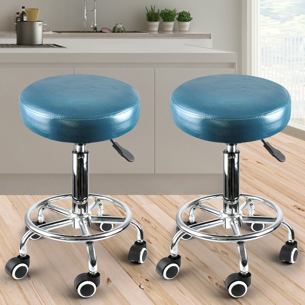Two teal Levede swivel salon barstools with a round cushion and chrome base, designed for hairdressing and barber use.