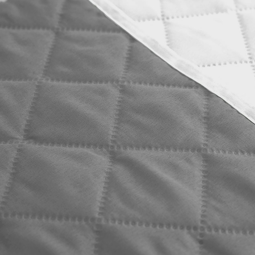Grey quilted 3 seater sofa cover with microfiber filling, showcasing its stylish design and protective features.