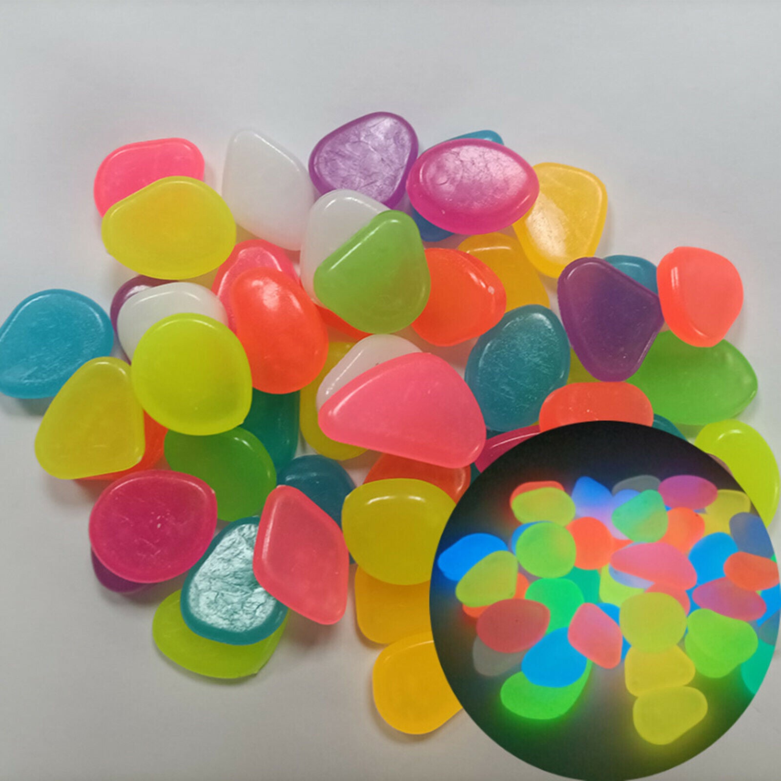 300PCS glow in the dark pebbles in various colors, ideal for garden and aquarium decoration, glowing brightly in a dark environment.