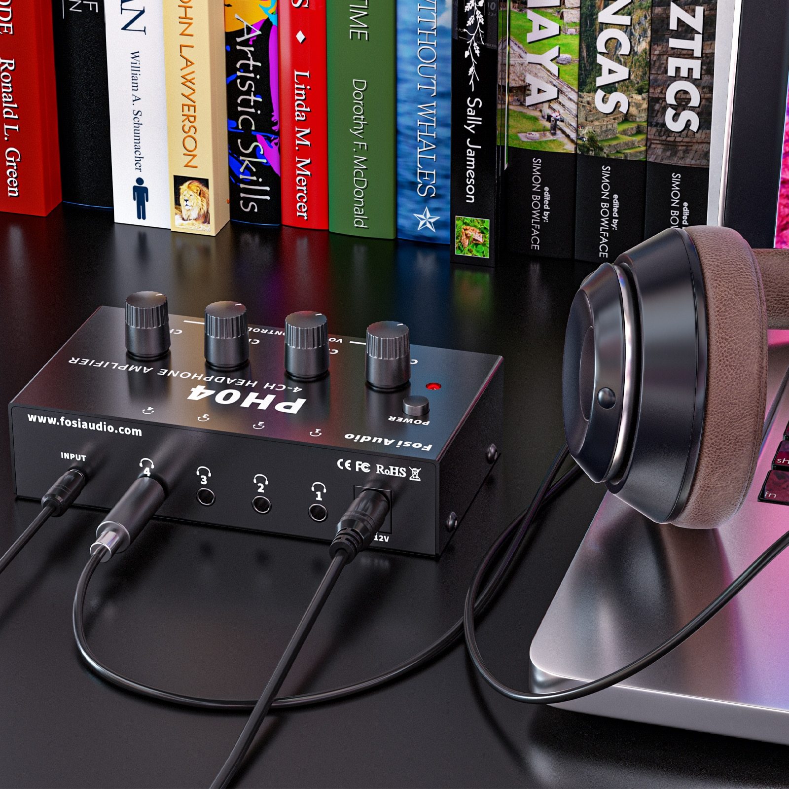 4 Channel Headphone Amplifier in a sleek metal design, showcasing its compact size and multiple headphone outputs.