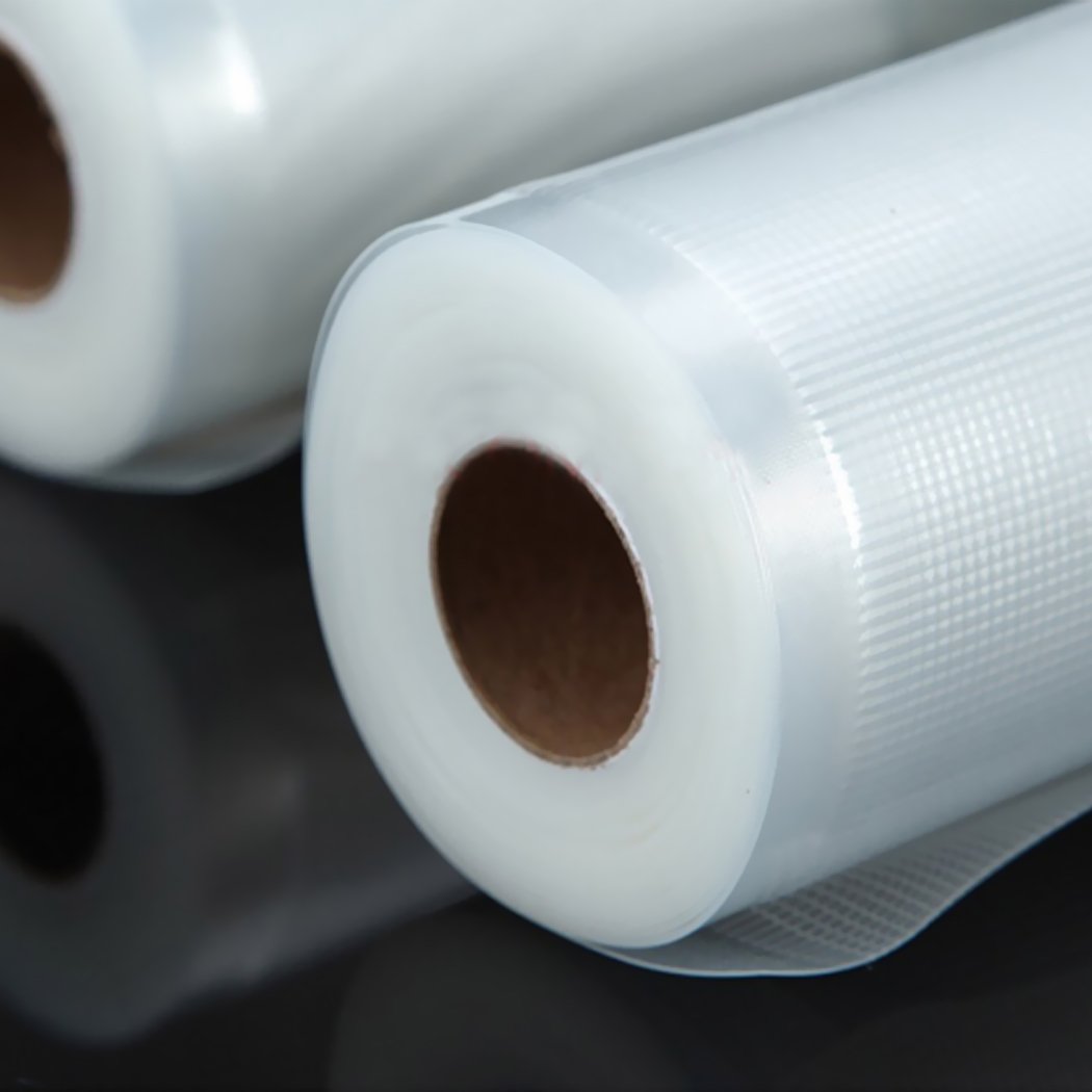 Four rolls of vacuum food sealer bags, clear and embossed, designed for food preservation and storage.