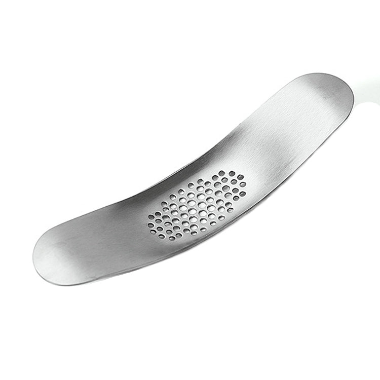 A 430 stainless steel boat shaped garlic grinder, showcasing its sleek design and evenly distributed holes for efficient garlic pressing.
