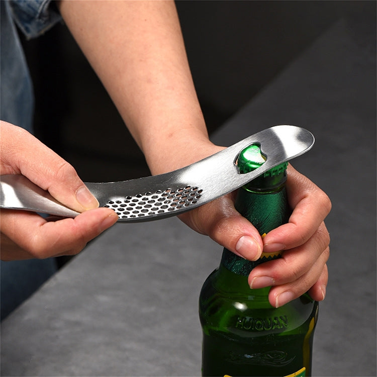 A 430 stainless steel boat shaped garlic grinder, showcasing its sleek design and evenly distributed holes for efficient garlic pressing.