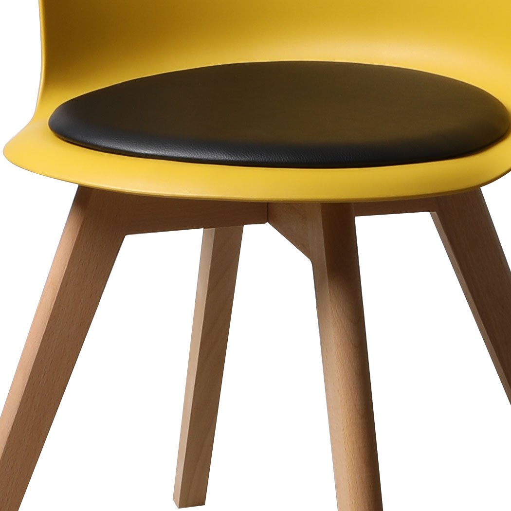 A stylish set of four office meeting chairs with PU leather seats in various colors, showcasing ergonomic design and sturdy beech wood legs.