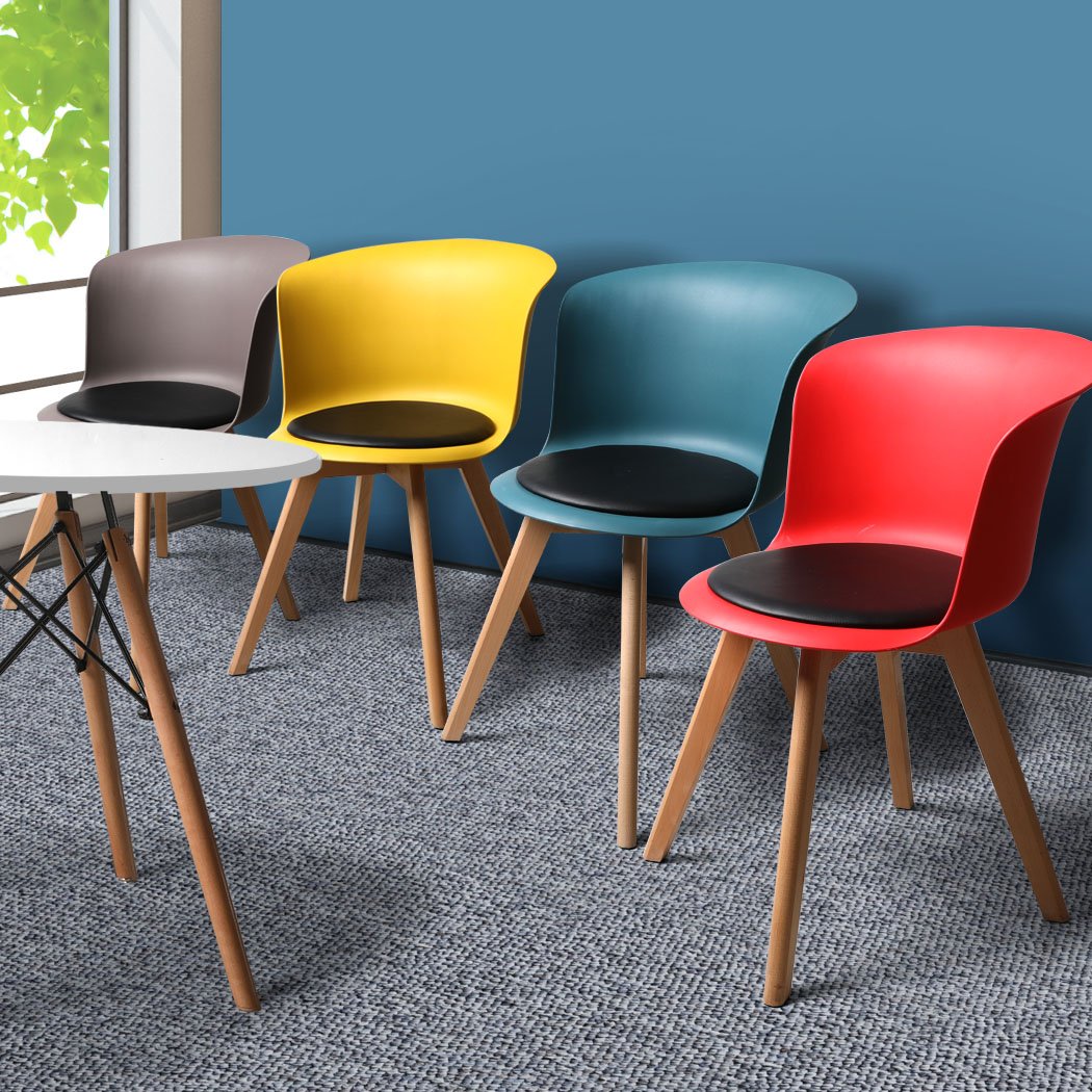 A stylish set of four office meeting chairs with PU leather seats in various colors, showcasing ergonomic design and sturdy beech wood legs.