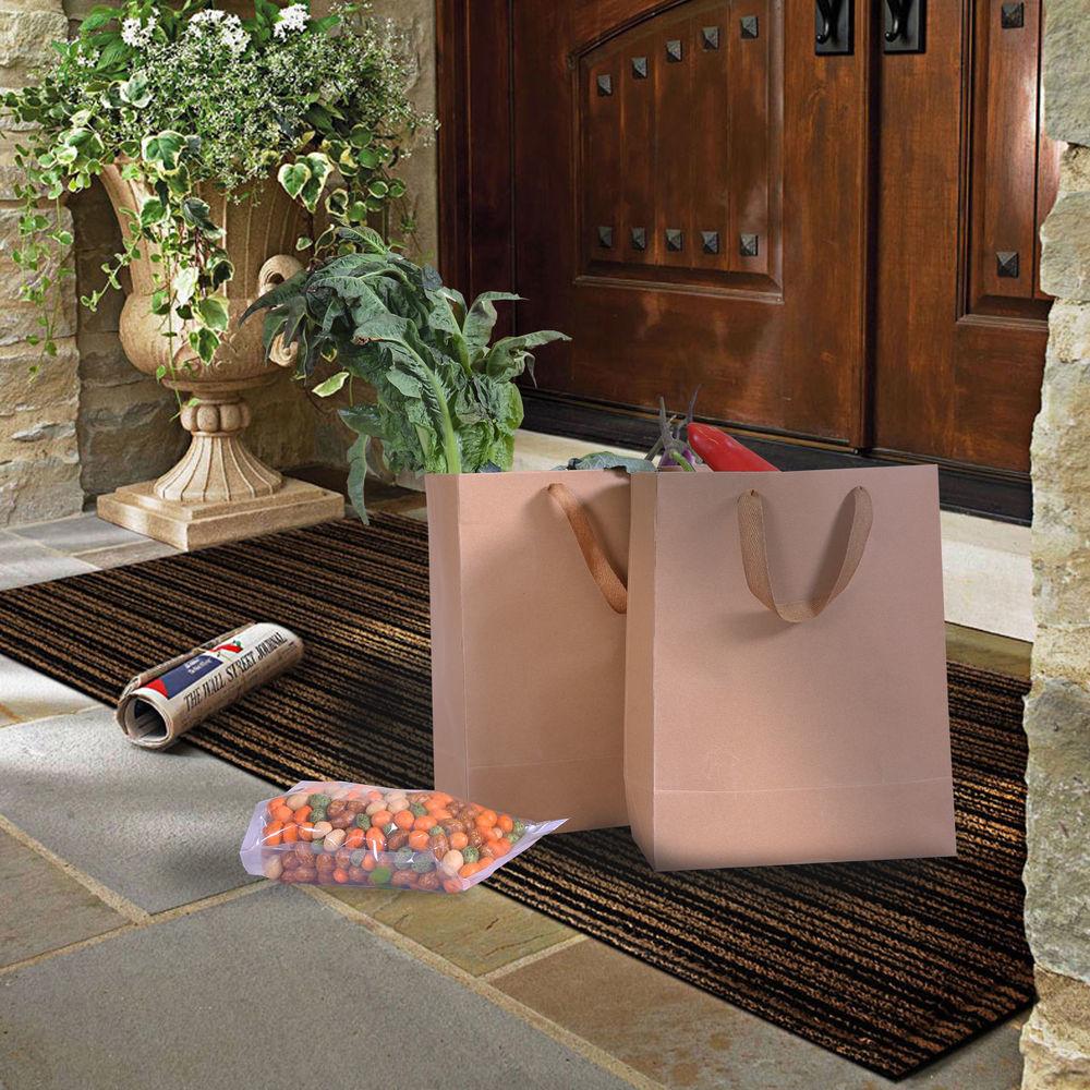 A stack of 50 eco-friendly brown paper bags with twisted handles, ideal for gifts and retail use.