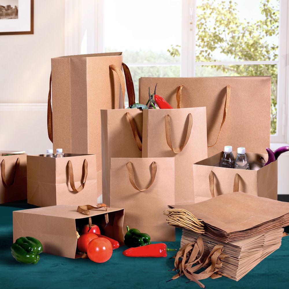 A stack of 50 eco-friendly brown paper bags with twisted handles, ideal for gifts and retail use.