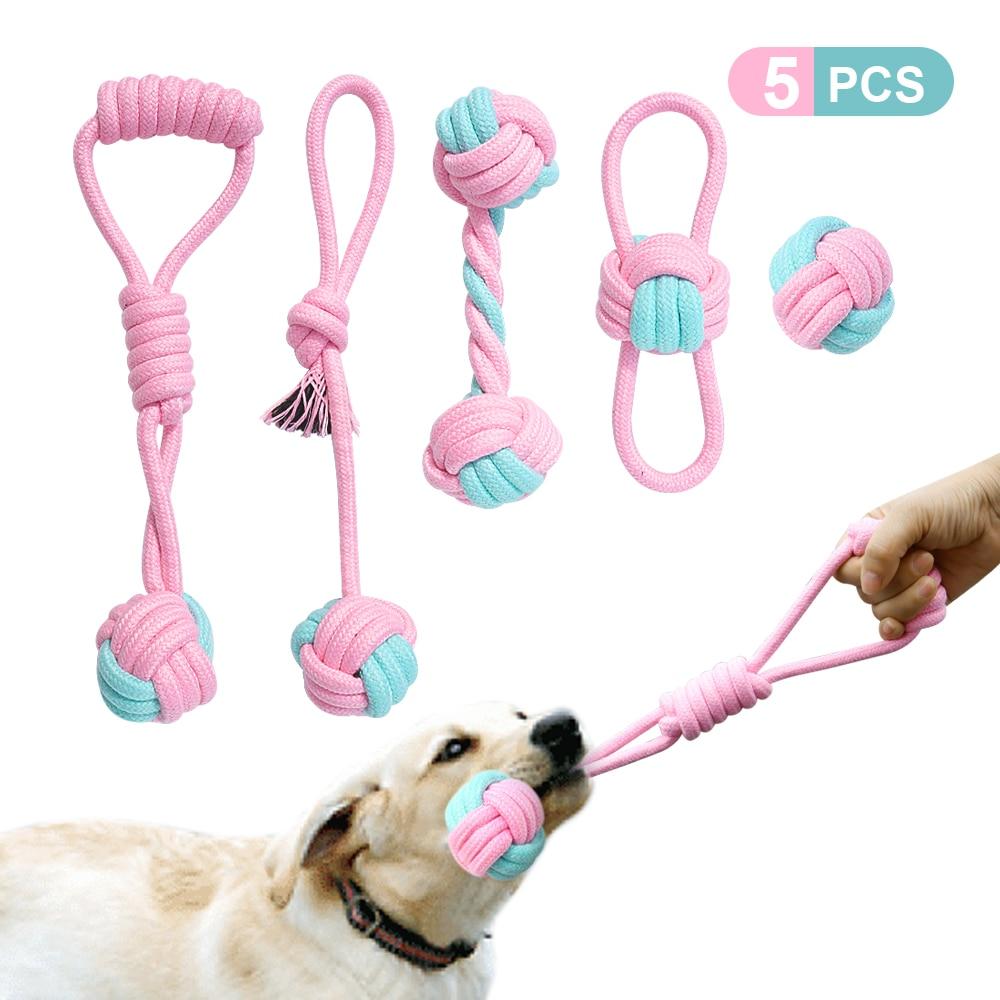 Five colorful cotton rope toys for dogs, designed for chewing and dental cleaning, featuring knots and a vibrant pink color.
