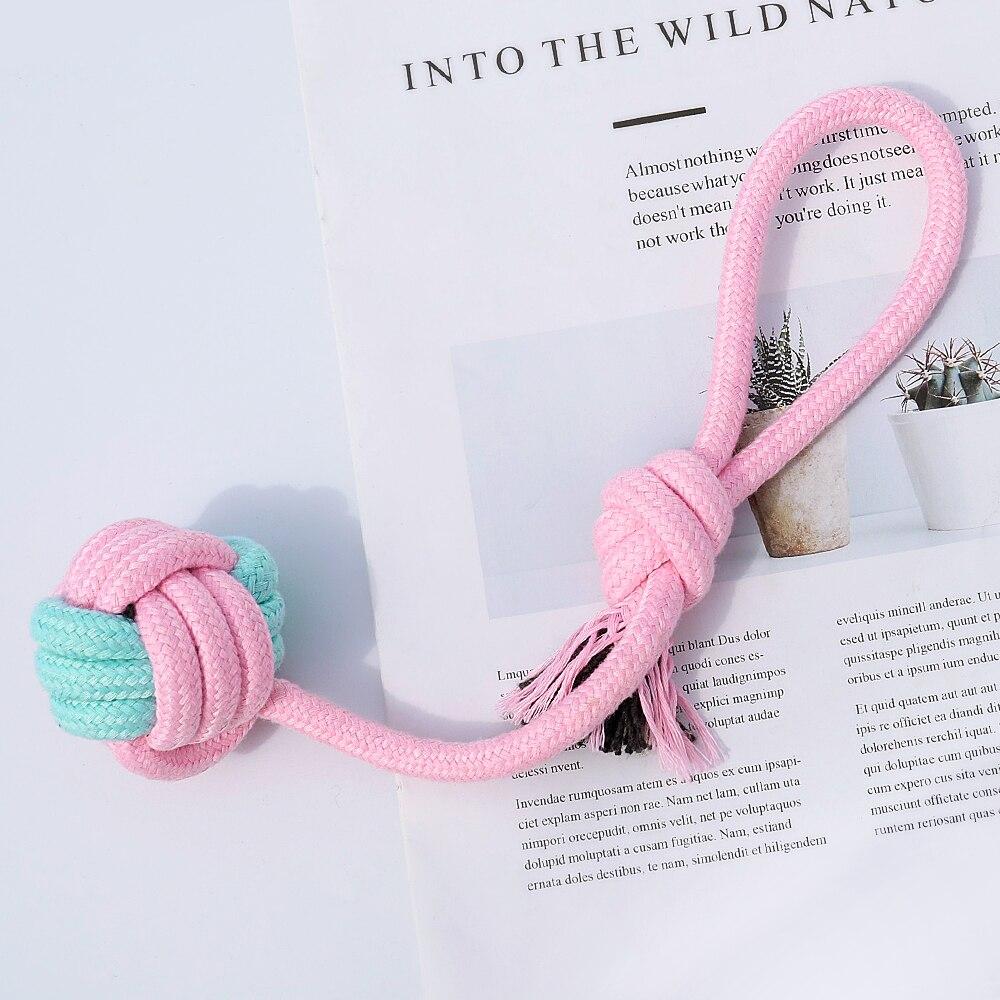 Five colorful cotton rope toys for dogs, designed for chewing and dental cleaning, featuring knots and a vibrant pink color.