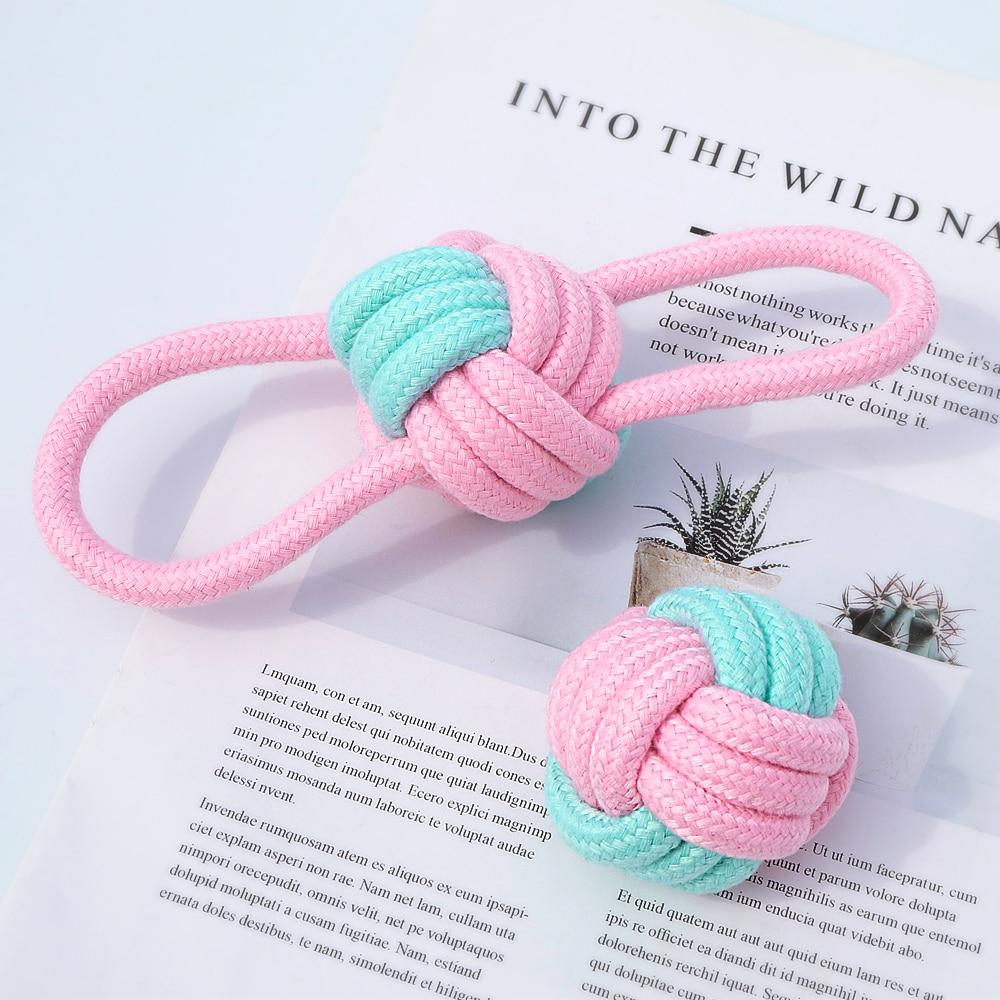 Five colorful cotton rope toys for dogs, designed for chewing and dental cleaning, featuring knots and a vibrant pink color.